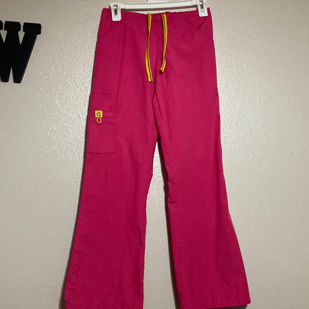 Size XS  Spread Good Cheer Hot Pink scrub bottoms with yellow drawstrings.